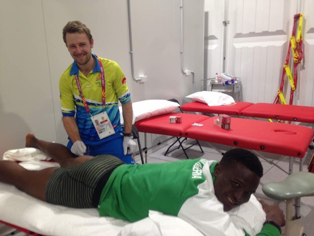 Jason Wheeler treating an athlete at the 2018 Commonwealth Games, Gold Coast